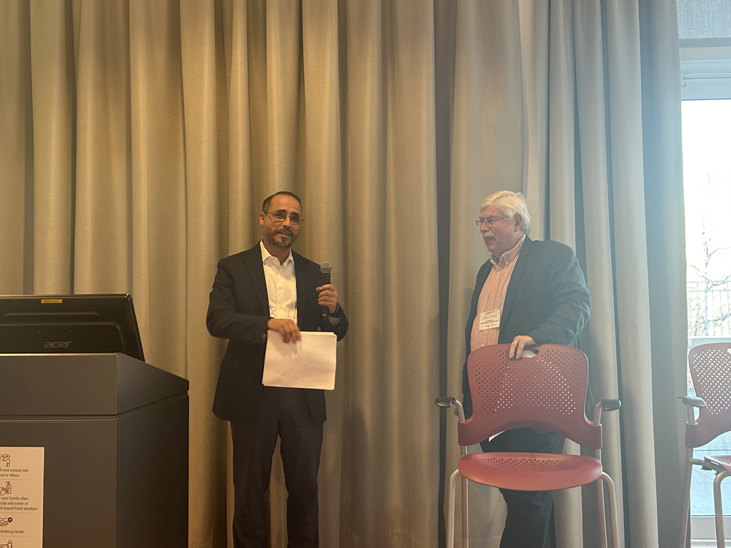 Elkafi Hassini and Bernie Uhlich engaged in a discussion after the event.